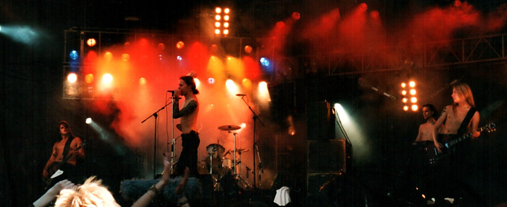 A person on stage with microphones and lights

Description automatically generated