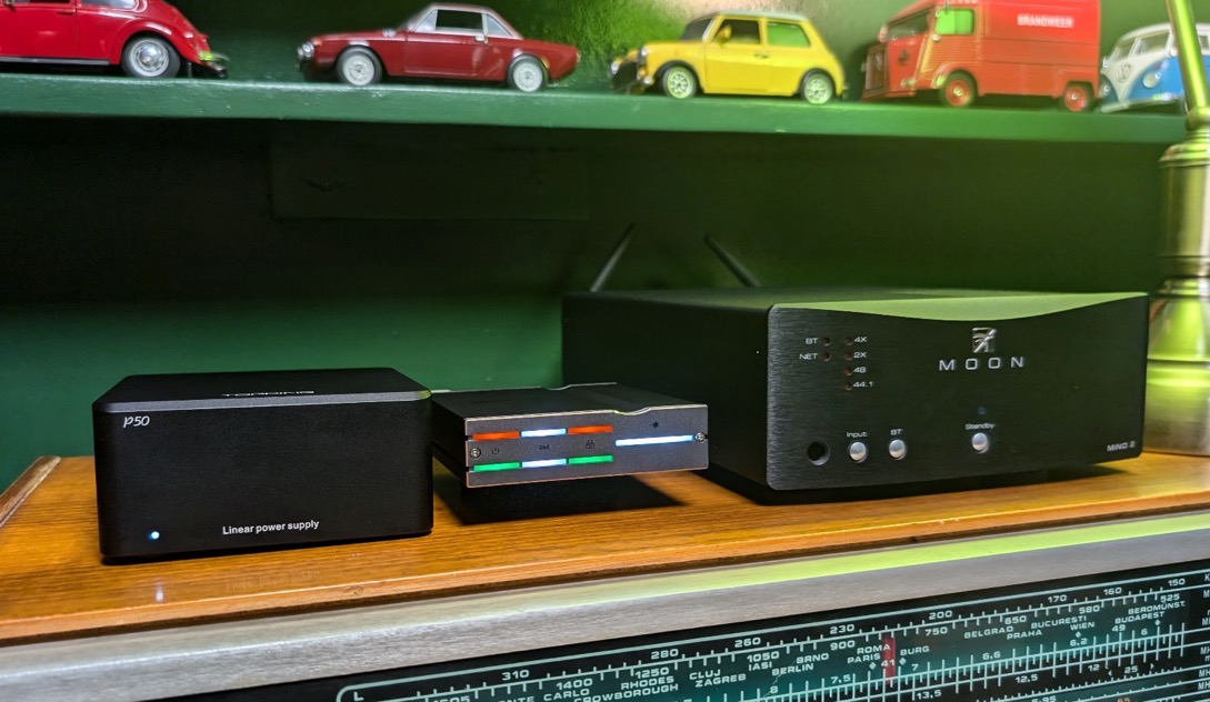 A group of black electronic devices on a shelf

Description automatically generated